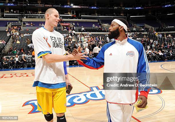 Maciej Lampe of Maccabi Electra Tel Aviv shakes hands with Baron Davis of the Los Angeles Clippers prior to a preseason game at Staples Center on...