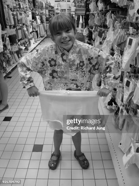 young girl holding large pair of women's underwear - women in girdles photos et images de collection