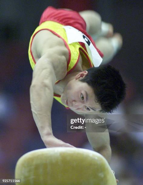 Li Xiaopeng of China performs on the vault at the men's artistic gymnastics all-round competition at the East Asian Games in Osaka, 20 May 2001. Li...