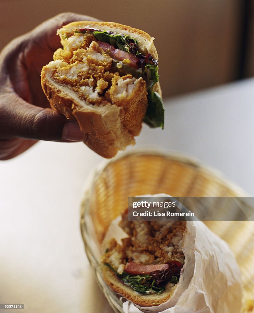 Hand with fried catfish po'boy