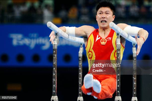 China's Li Xiaopeng competes in the men's parrallel bars final of the artistic gymnastics event of the Beijing 2008 Olympic Games in Beijing on...