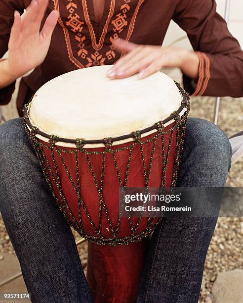 woman beating drum - djembe foto e immagini stock