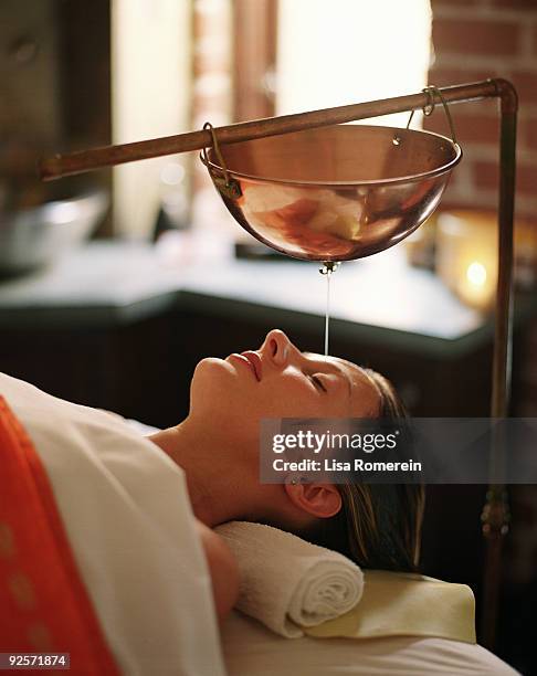 woman getting ayurvedic treatment - ayurveda stock pictures, royalty-free photos & images