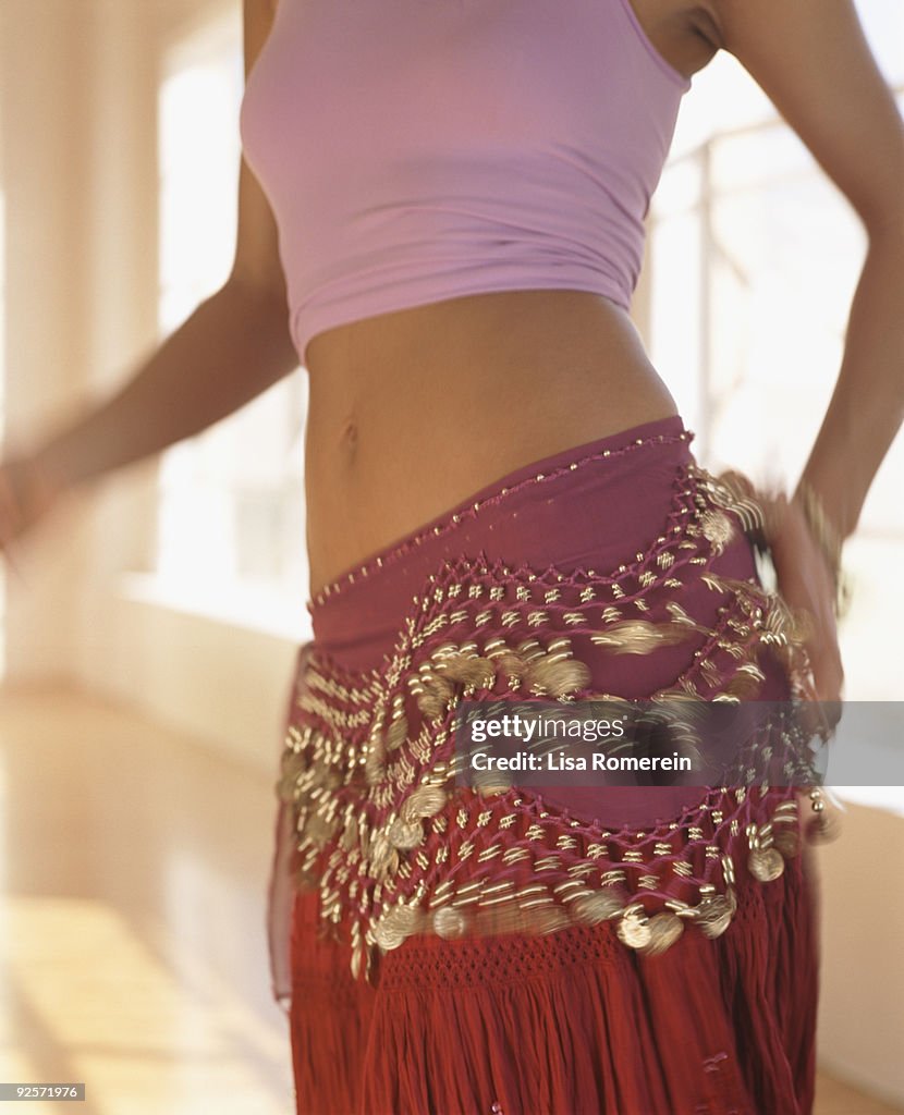 Midsection of woman belly dancing