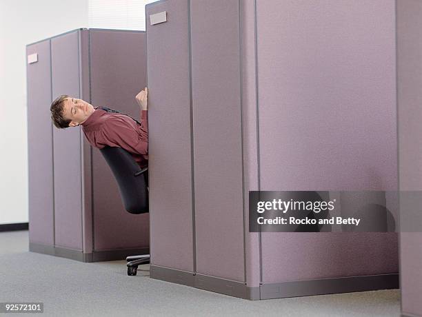 business leaning back in cubicle - peeking cubicle stock pictures, royalty-free photos & images