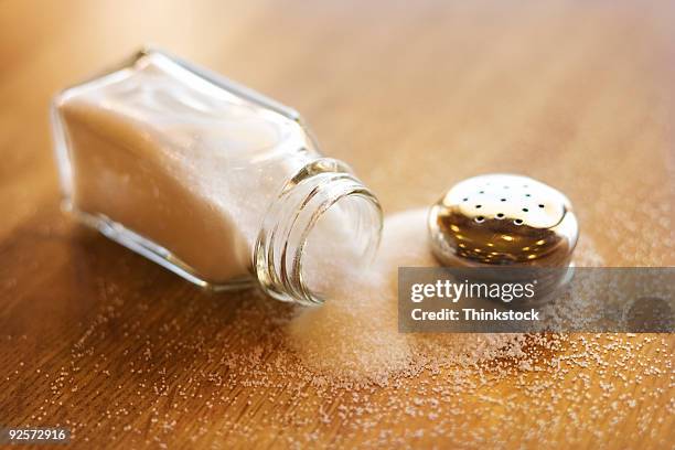 spilled salt shaker - salt shaker stockfoto's en -beelden