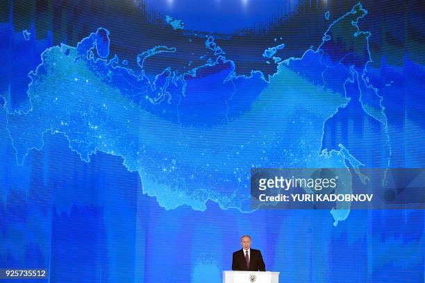 Russian President Vladimir Putin addresses the Federal Assembly at Moscow's Manezh exhibition centre on March 01, 2018.