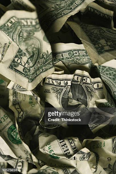 pile of crumpled dollar bills - thinkstock fotografías e imágenes de stock