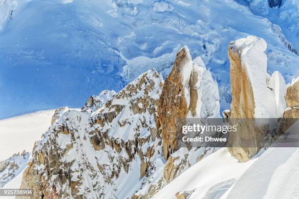 granite crags covered with snow, mont blanc massif, france - aiguille de midi imagens e fotografias de stock