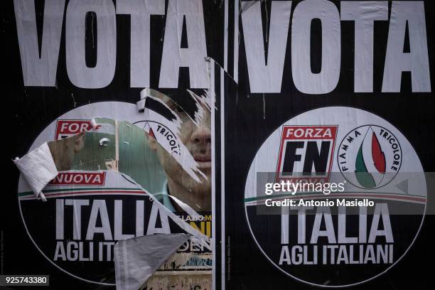 Damaged election poster for the far-right political party, Forza Nuova and Fiamma Tricolore is seen on the street in Rome for the upcoming general...