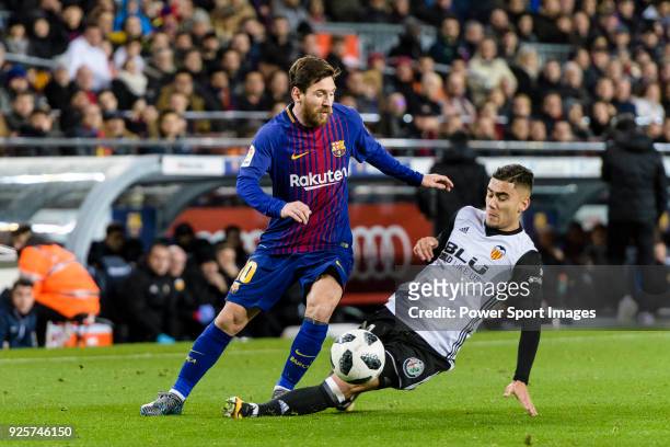 Andreas Pereira of Valencia CF trips up with Lionel Messi of FC Barcelona during the Copa Del Rey 2017-18 match between FC Barcelona and Valencia CF...