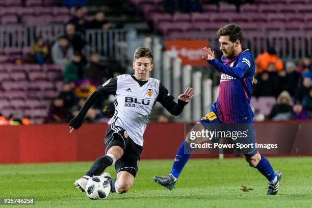 Lionel Messi of FC Barcelona fights for the ball with Luciano Vietto of Valencia CF during the Copa Del Rey 2017-18 match between FC Barcelona and...