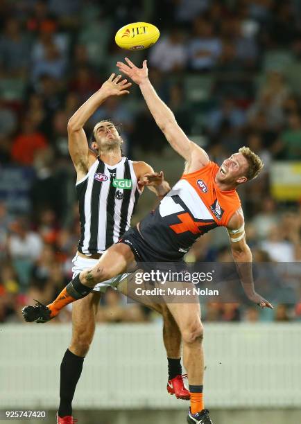 Brodie Grundy of the Magpies and Dawson Simpson of the Giants contest possession during the JLT Community Series AFL match between the Greater...