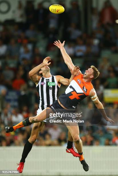 Brodie Grundy of the Magpies and Dawson Simpson of the Giants contest possession during the JLT Community Series AFL match between the Greater...