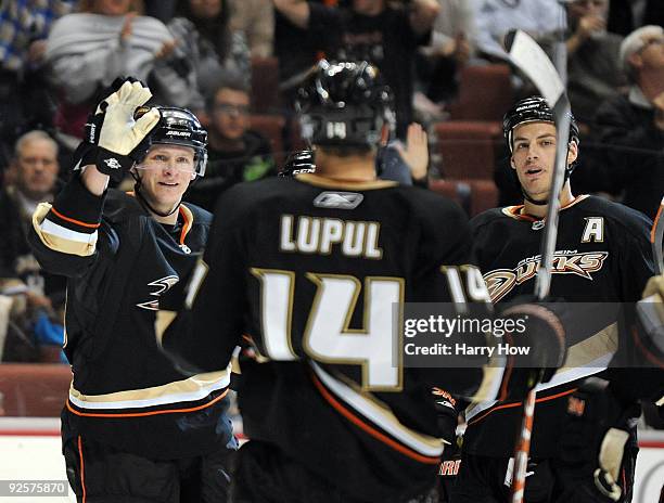 Corey Perry of the Anaheim Ducks celebrates his goal with Ryan Getzlaf and Joffrey Lupul against the Vancouver Canucks during the first period at the...