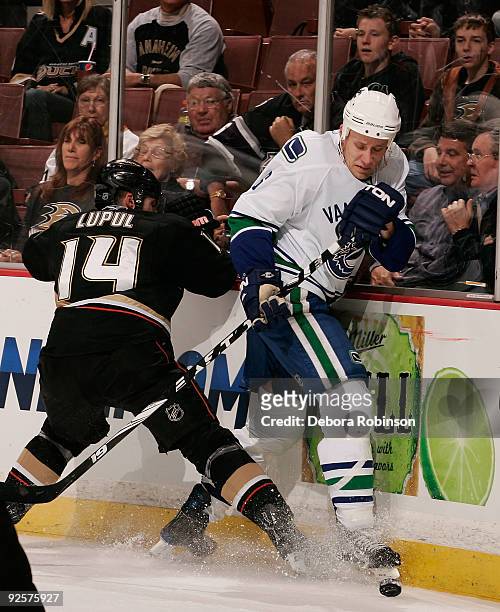 Sami Salo of the Vancouver Canucks fights against Joffrey Lupul of the Anaheim Ducks during the game on October 30, 2009 at Honda Center in Anaheim,...
