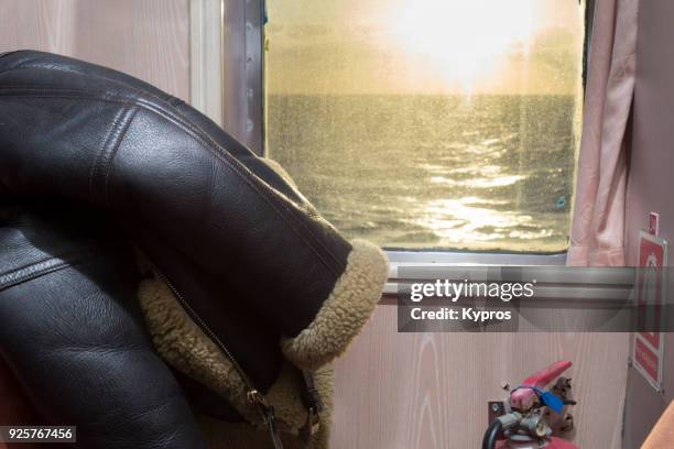 europe, greece, 2018: view of sheepskin flying jacket on ferry boat - sheepskin boot stock-fotos und bilder