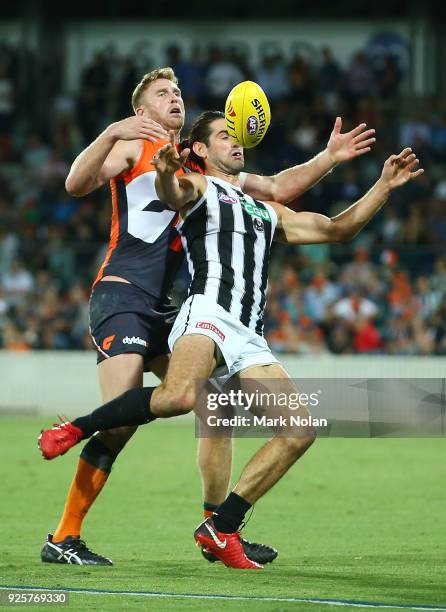 Brodie Grundy of the Magpies and Dawson Simpson of the Giants contest possession during the JLT Community Series AFL match between the Greater...