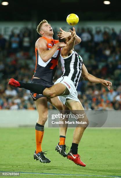 Brodie Grundy of the Magpies and Dawson Simpson of the Giants contest possession during the JLT Community Series AFL match between the Greater...