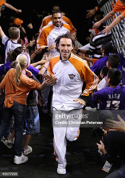 Steve Nash of the Phoenix Suns leads teammates out onto the court before the NBA game against the Golden State Warriors at US Airways Center on...