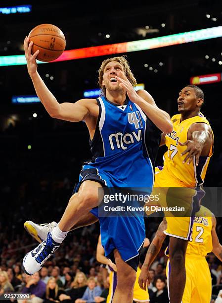 Dirk Nowitzki of the Dallas Mavericks drives to the basket for the score against Ron Artest of the Los Angekes Lakers during the third quarter of the...