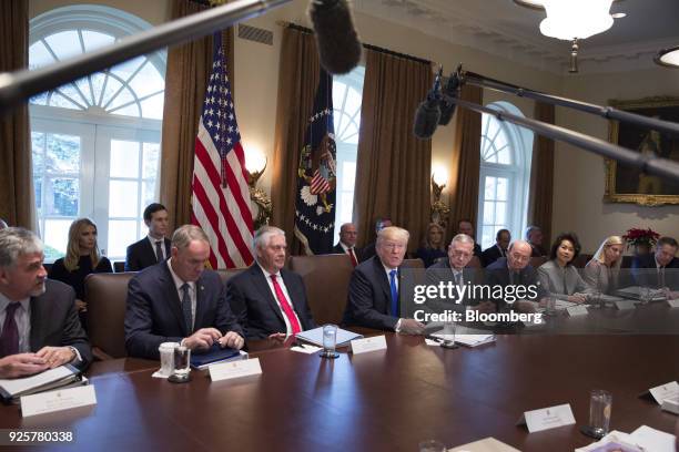 President Donald Trump, center, speaks during a cabinet meeting at the White House as Ivanka Trump, assistant to the U.S. President, and her husband...