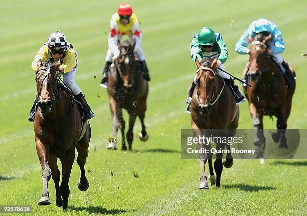 Michael Rodd riding Faint Perfume crosses the line to win the Lexus Stakes during the 2009 Victoria Derby Day meeting at Flemington Racecourse on...