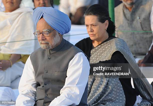 Indian Prime Minister Manmohan Singh and Congress Party President and United Progressive Alliance Chairperson Sonia Gandhi pay their respects at...