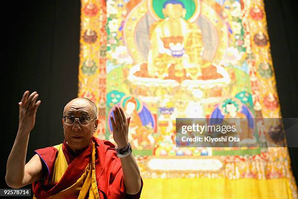 His Holiness the 14th Dalai Lama greets the audience prior to the lecture 'Three Principle Paths and Generating the Altruistic Mind Enlightenment' at...
