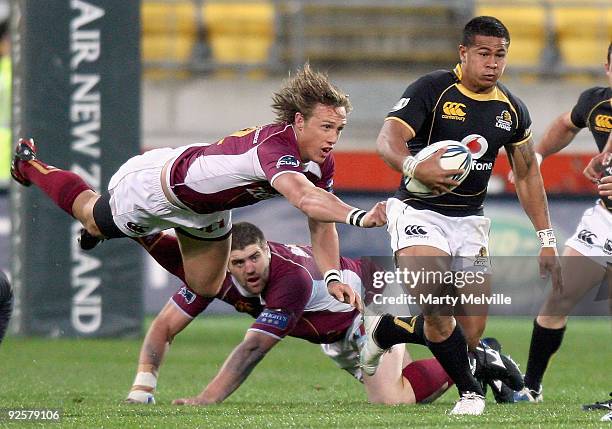 David Smith of Wellington is tackled by James Wilson of Southland during the Air New Zealand Cup Semi Final match between Wellington and Southland at...