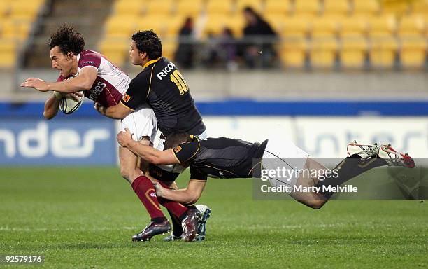 Jason Kawau of Southland is tackled by Piri Weepu and Shaun Treeby of Wellington during the Air New Zealand Cup Semi Final match between Wellington...