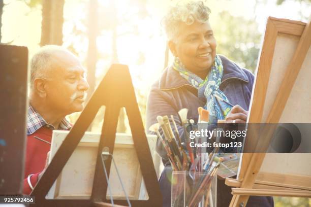 active senior adult couple enjoys art hobby outdoors. - indian elderly couple stock pictures, royalty-free photos & images