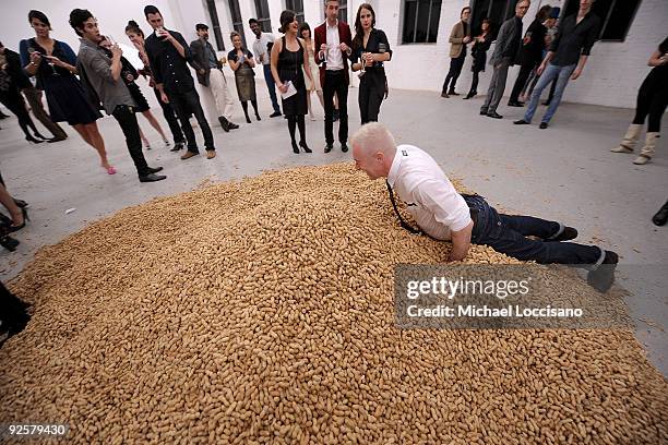 Actor Alan Cumming dives into the pile of peanuts during the Performa 09 Opening Night Benefit Dinner at X Initiative on October 30, 2009 in New York...