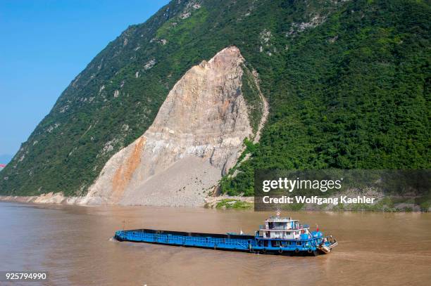 River barge in the Wu Gorge and a landslide, Yangtze River, China.