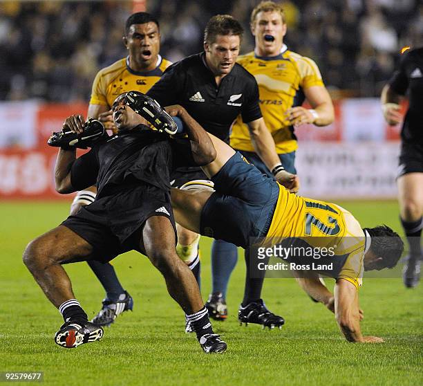 Sitiveni Sivivatu of the All Blacks makes an illegal tackle on Adam Ashley-Cooper of the Wallabies during the 2009 Bledisloe Cup match between the...