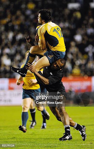 Sitiveni Sivivatu of the All Blacks makes an illegal tackle on Adam Ashley-Cooper of the Wallabies during the 2009 Bledisloe Cup match between the...