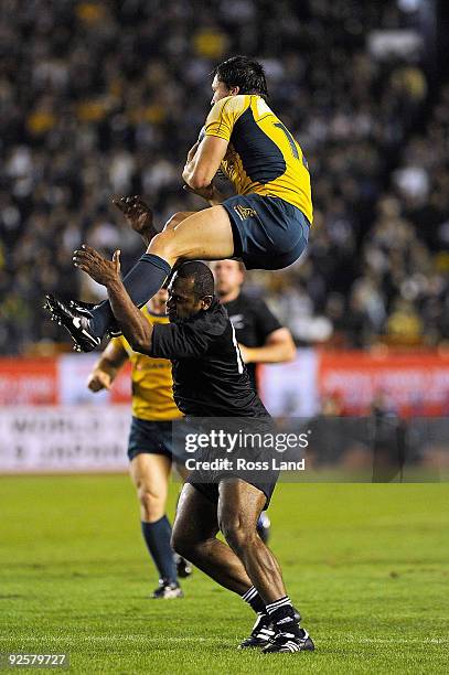 Sitiveni Sivivatu of the All Blacks makes an illegal tackle on Adam Ashley-Cooper of the Wallabies during the 2009 Bledisloe Cup match between the...