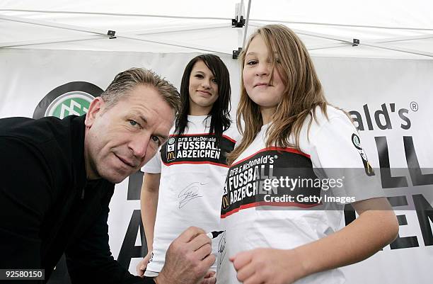 Andreas Koepke signs shirts of football girls during the 2500th DFB Football Badge on October 31, 2009 in Vorbach, Germany.