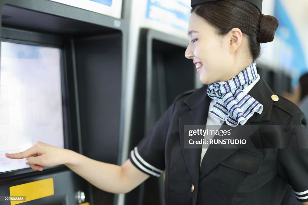 Flight Attendant Using Ticket Machine At The Airport High-Res Stock ...
