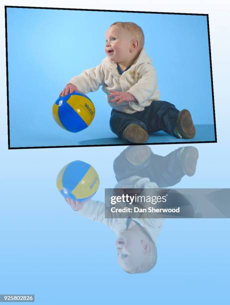 boy with his ball on his 9 month birthday - dan sherwood photography - fotografias e filmes do acervo