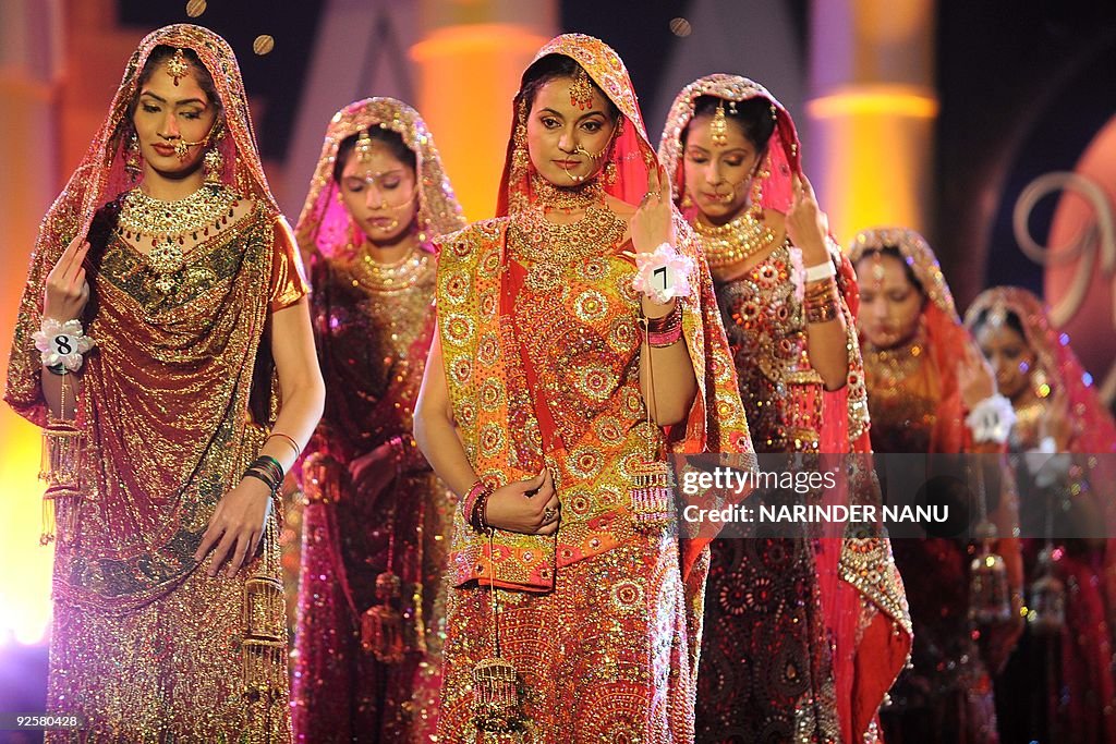Indian Pakistani Ramp Model Indian models walk the ramp wearing traditional wedding dresses... News ...