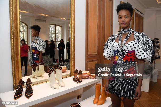 Model poses next to shoes made for Emanuel Ungaro by Malone Souliers during the Emanuel Ungaro presentation as part of the Paris Fashion Week...