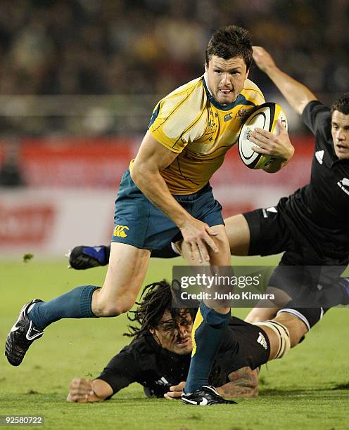 Adam Ashley-Cooper of the Wallabies runs with the ball during the 2009 Bledisloe Cup match between the New Zealand All Blacks and the Australian...