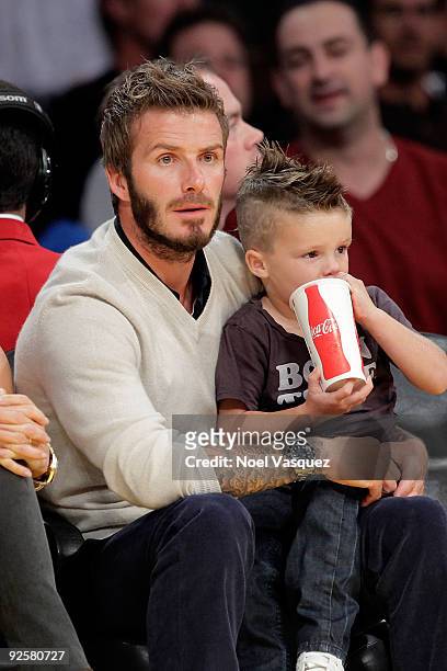 David Beckham and son Romeo Beckham attend the Los Angeles Lakers v Dallas Mavericks game on October 30, 2009 in Los Angeles, California.