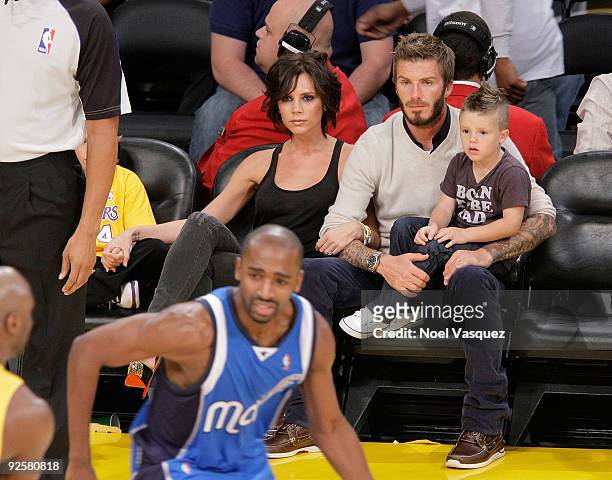 Victoria Beckham, David Beckham and Romeo Beckham attend the Los Angeles Lakers v Dallas Mavericks game on October 30, 2009 in Los Angeles,...