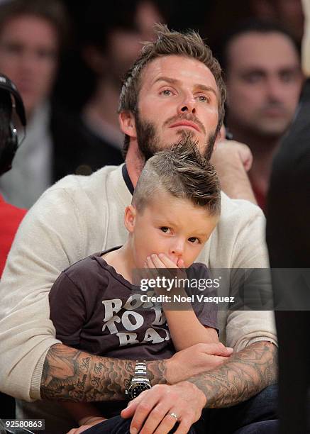 David Beckham and son Romeo Beckham attend the Los Angeles Lakers v Dallas Mavericks game on October 30, 2009 in Los Angeles, California.