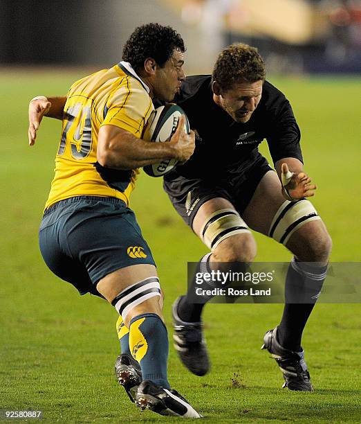 George Smith of the Wallabies is tackled by Kieran Read of the All Blacks during the 2009 Bledisloe Cup match between the New Zealand All Blacks and...