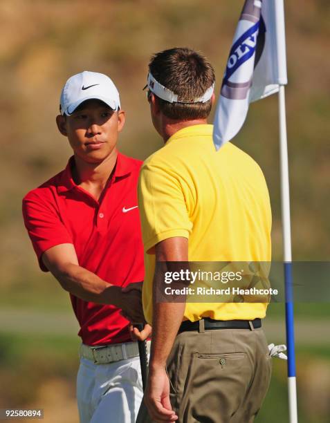 Anthony Kim of USA shakes hands with Robert Allenby of Australia on the 18th green during the Semi Finals of the Volvo World Match Play Championship...