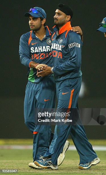 Virat Kohli congratulates Harbhajan Singh of India after a wicket during the third One Day International match between India and Australia at Feroz...