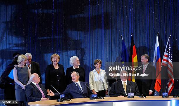 Giant shadow of a tv-camera is seen at the family photo with former Soviet President Mikhail Gorbatchev, German Chancellor Angela Merkel, former US...